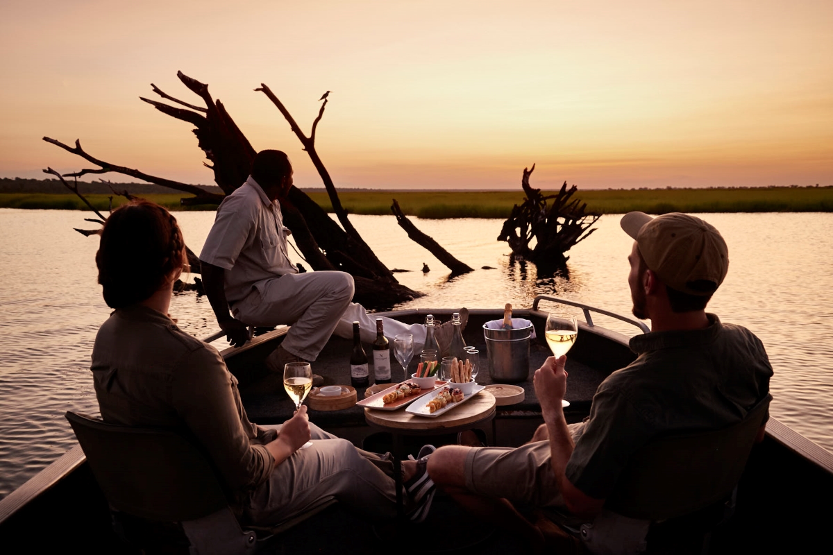 Sanctuary-Chobe-Chilwero-sundowner-boat-safari Couple on a private sundowner boat trip with snacks